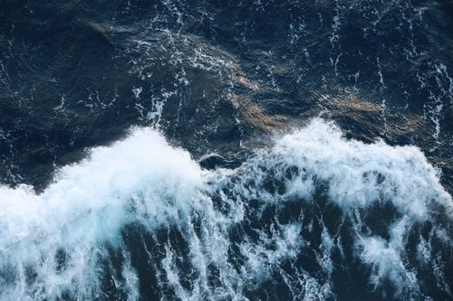 Free Stunning aerial view capturing the vibrant energy of crashing ocean waves. Stock Photo