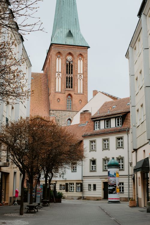 Free Explore a quaint German street with a stunning Gothic cathedral tower. Stock Photo