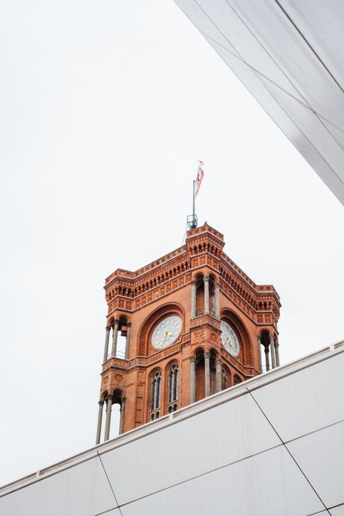 Free Low angle shot of the Rotes Rathaus clock tower, Berlin's iconic red brick landmark. Stock Photo