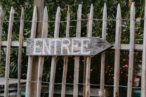 Wooden Entrance Signage on a Fence
