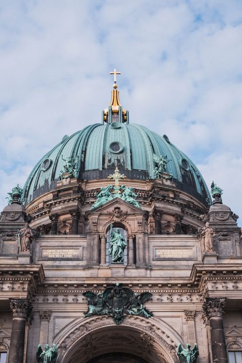 Free Close-up of Berlin Cathedral's majestic dome with a cloudy sky background, capturing its historic architecture. Stock Photo