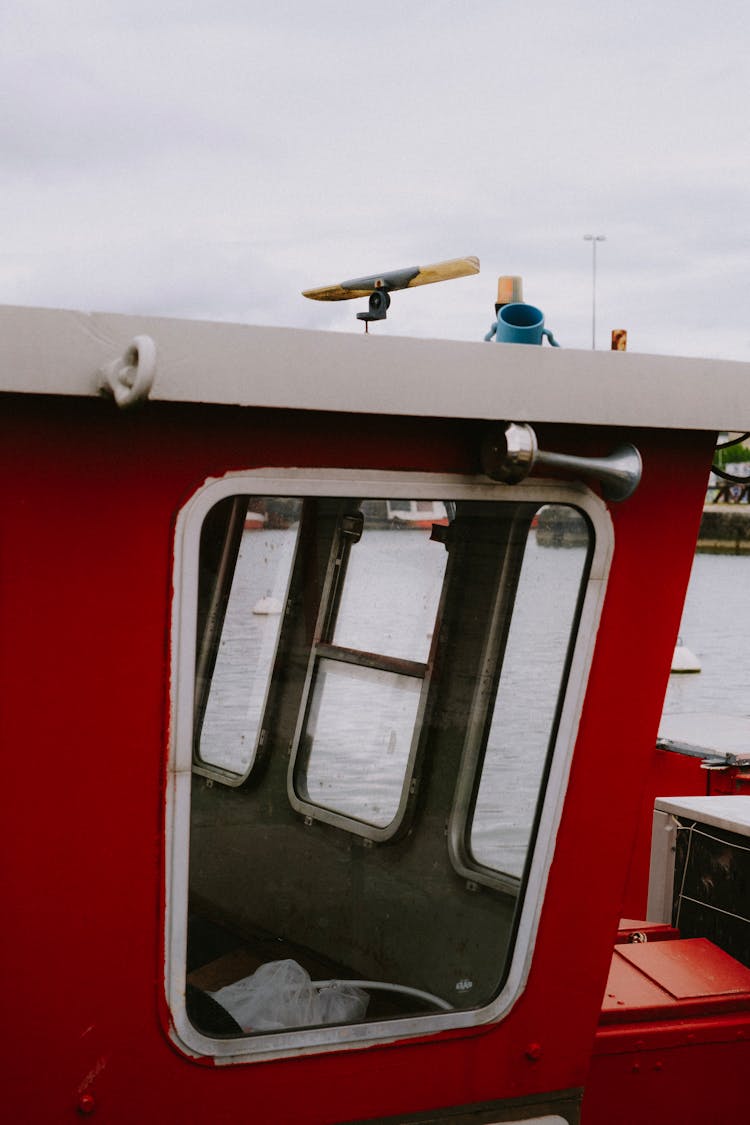 Window Of A Red Painted Ship