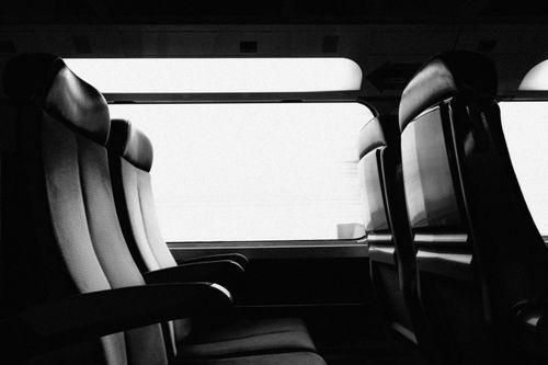 Free Black and white image featuring empty train seats and windows, showcasing a minimalist design. Stock Photo