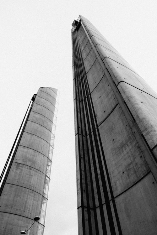 Free Low-angle black and white photo of modern skyscrapers with a minimalistic design. Stock Photo