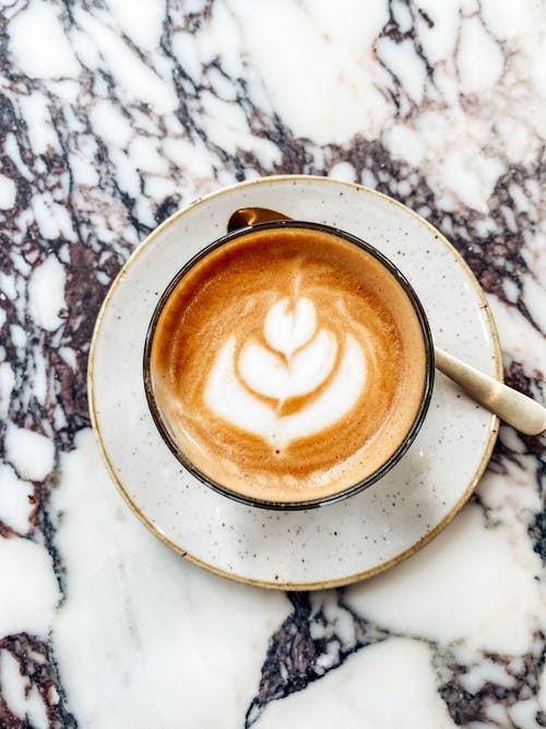 Cup Of Delicious Cappuccino With Latte Art On Top