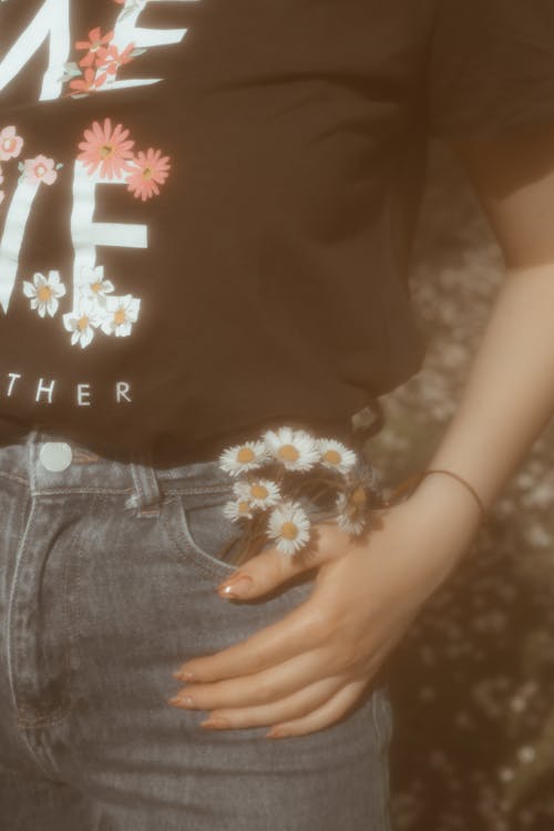 Free Hand with Flowers over Pocket Stock Photo