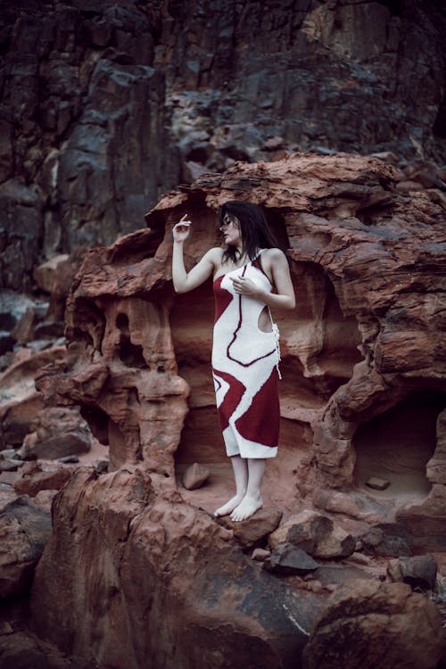 Fashion Model Posing Barefoot on an Eroded Rock Formation