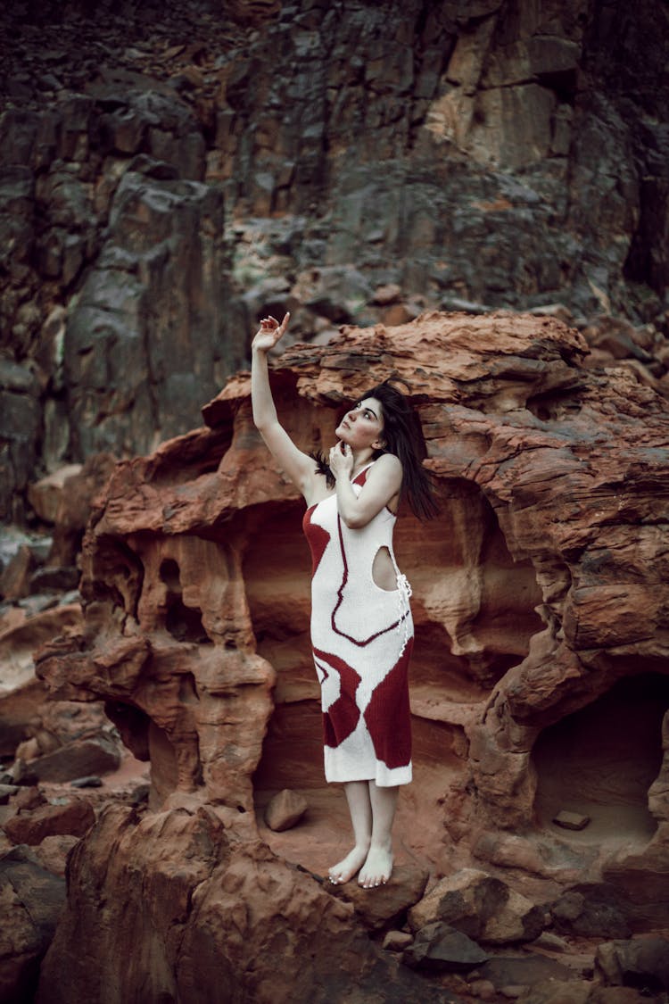 Model In A Dress Posing On A Rock Formation 