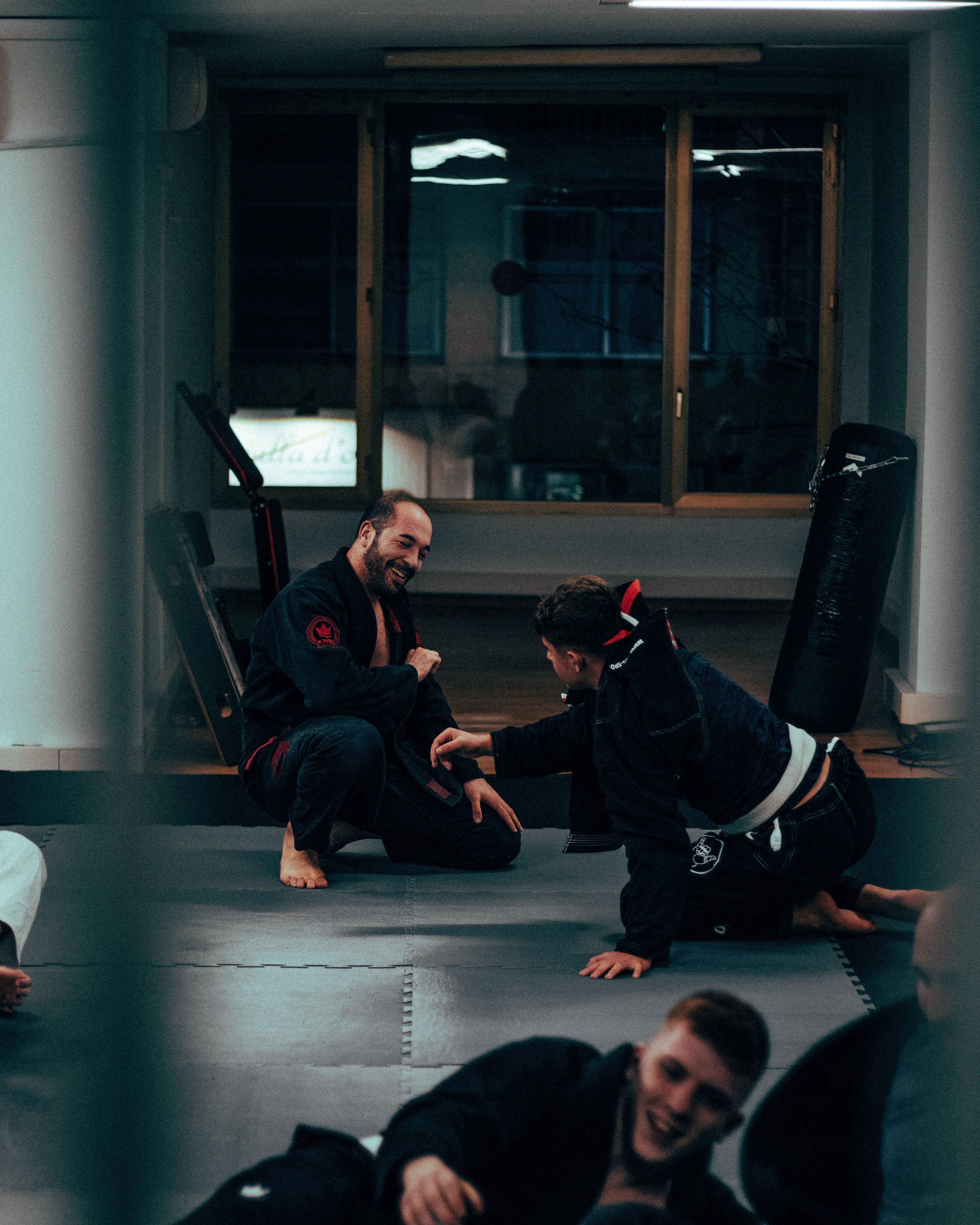 Martial Arts Trainees and Trainers on Mats · Free Stock Photo