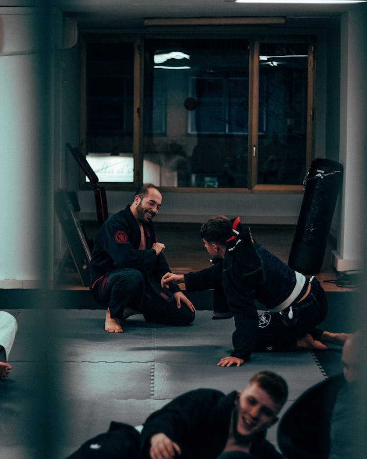 Martial Arts Trainees And Trainers On Mats