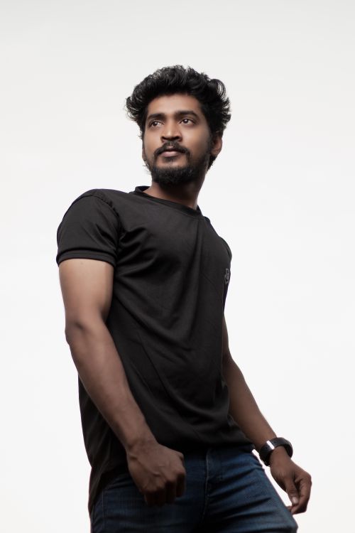 Free Portrait of a confident South Asian man posing in casual attire against a white background. Stock Photo
