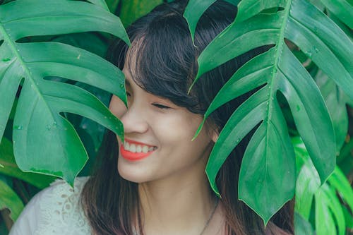 Free Close-Up Photography of Girl Near Leaves Stock Photo