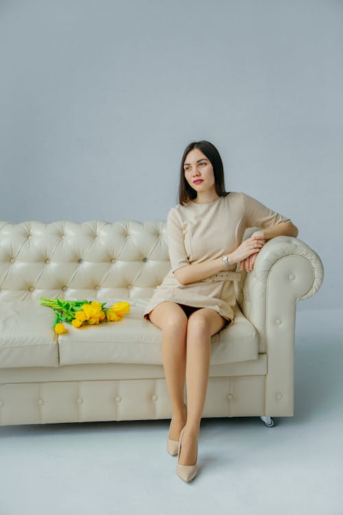 Free Woman Sitting on Couch Stock Photo