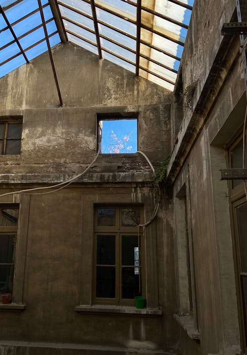 Empty Interior of an Abandoned House With a Glass Ceiling