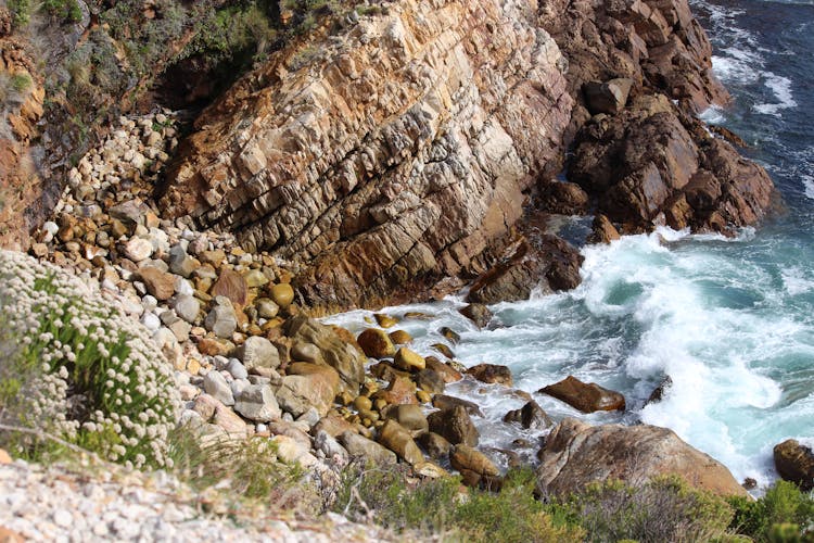 Waves Crashing Onto Cliff On Sea Shore