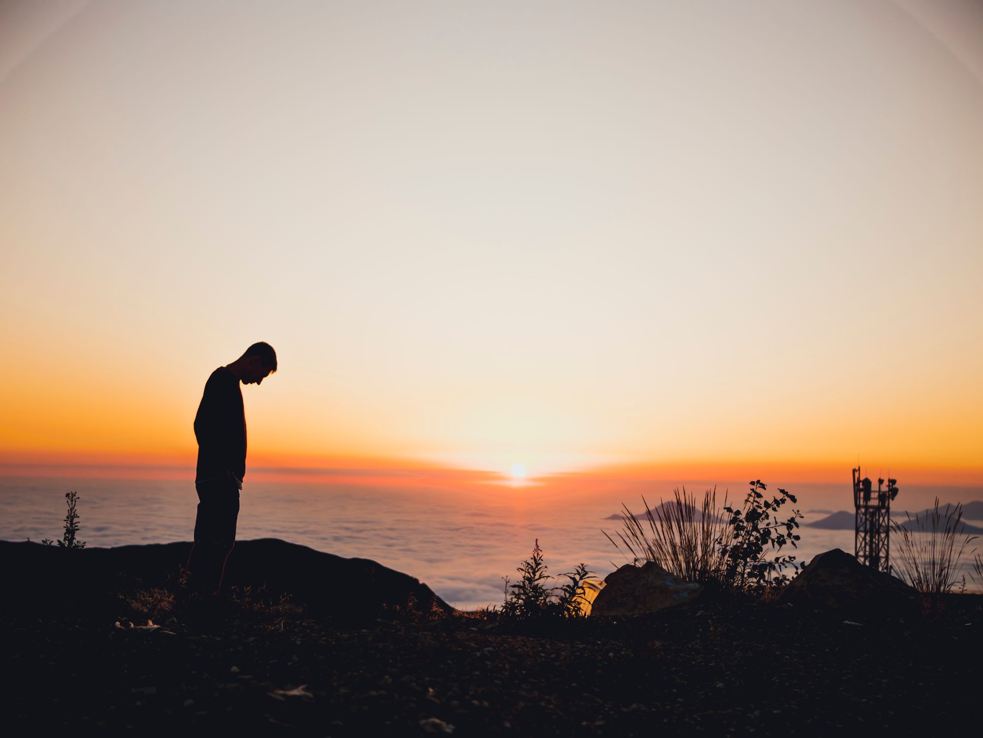 Silhouette of Man Standing Near Sea during Golden Hour · Free Stock Photo