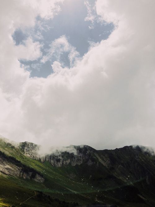 Free A breathtaking view of a mountain range shrouded in clouds, showcasing nature's beauty. Stock Photo