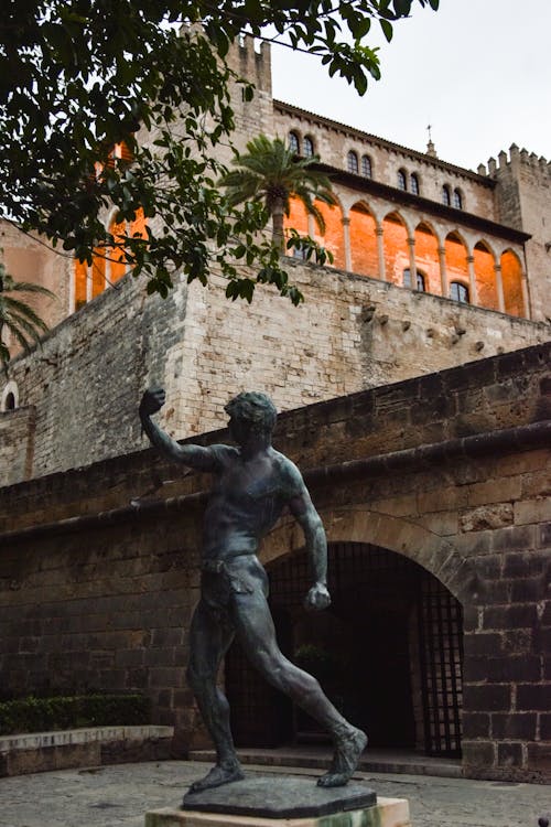 Free Balearic Slinger Statue at Royal Palace of La Almudaina in Palma, Spain Stock Photo