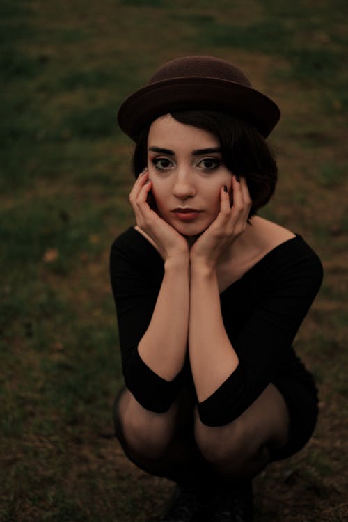 A Woman in Black Dress and Hat