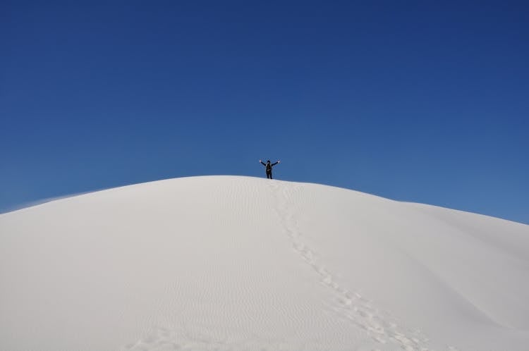 Person On Top Of A Snow Covered Mountain