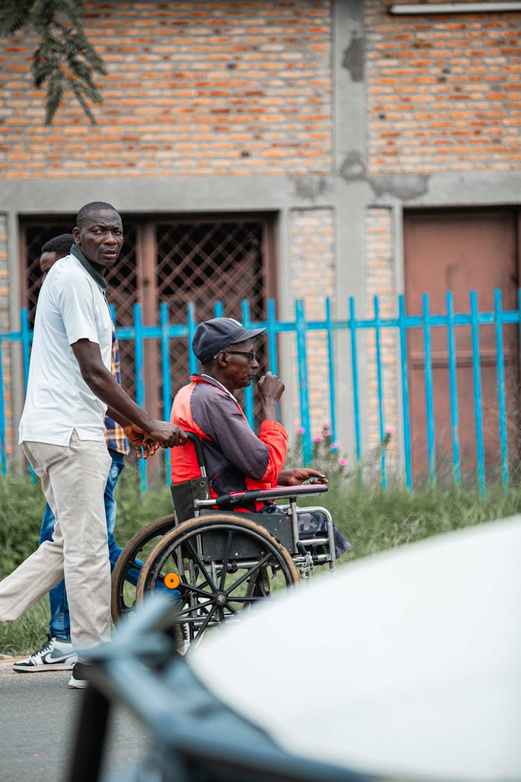 An Elderly Man Sitting On The Wheelchair