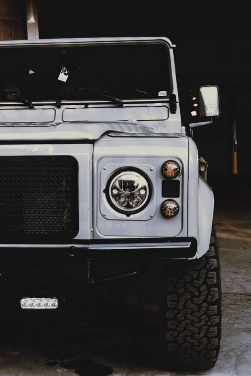 Free Detailed close-up of a Land Rover Defender's front in an Ottawa, Canada garage. Rustic and rugged appeal. Stock Photo
