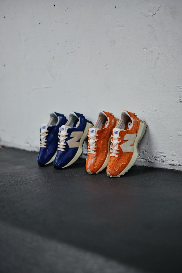 Two Pairs Of Sports Shoes Leaning Against A Wall