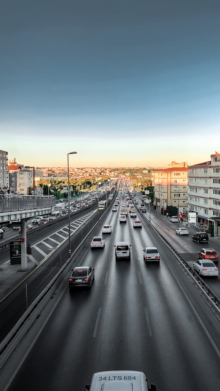 Vehicles Driving Along Highway In City