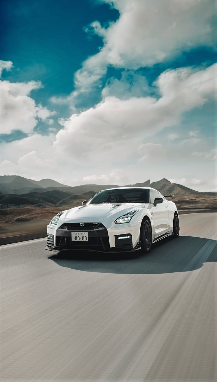 White And Black Car On Road Under Blue Sky