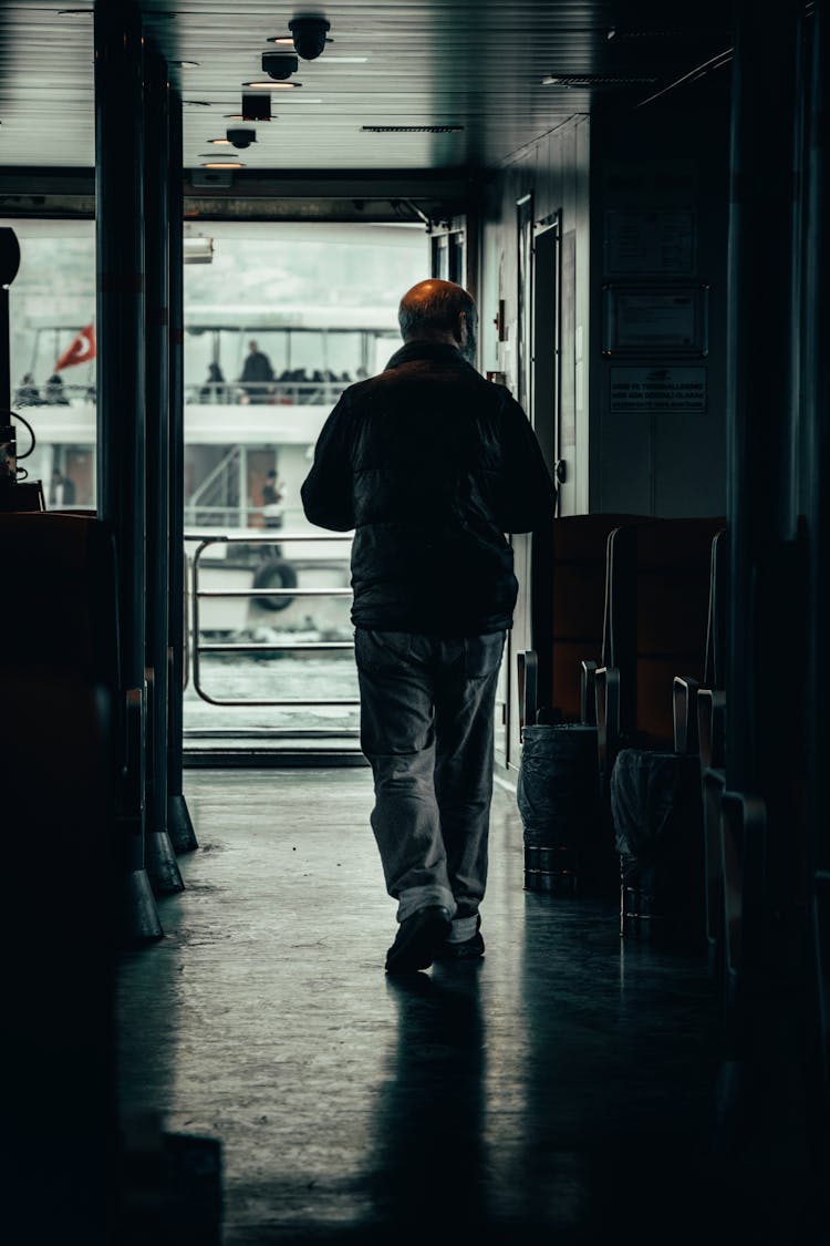 Man Walking Through The Hall On A Boat 