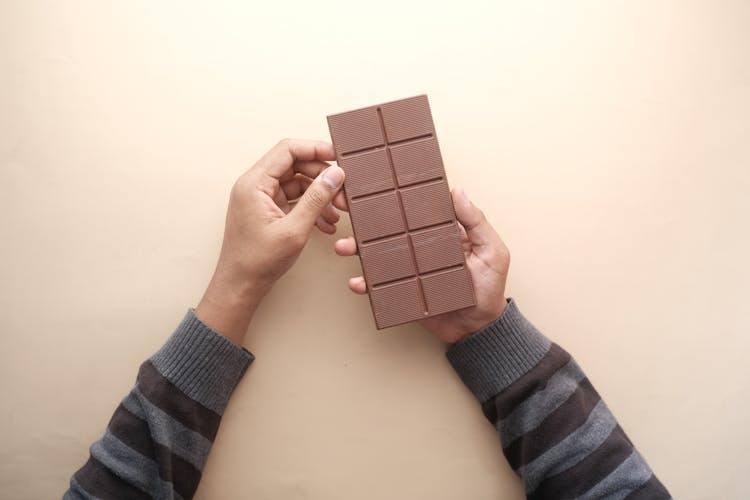 Man Holding Chocolate Bar In Hands