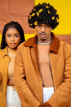 Stylish fashion portrait of two young models wearing modern outfits with bold colors in Botswana.