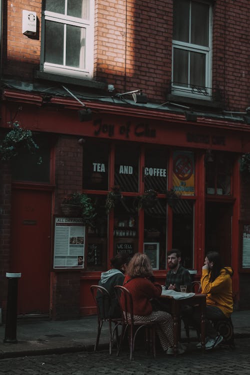 People Sitting At The Table At The Cafe