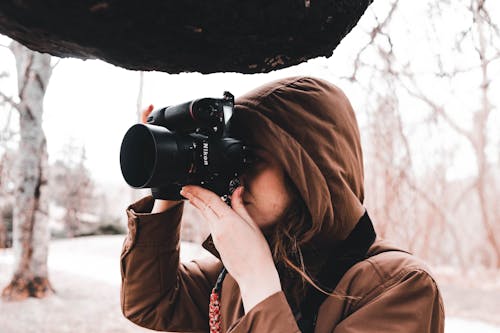 Free Close Up Photo of Woman Taking Photo with a Camera Stock Photo