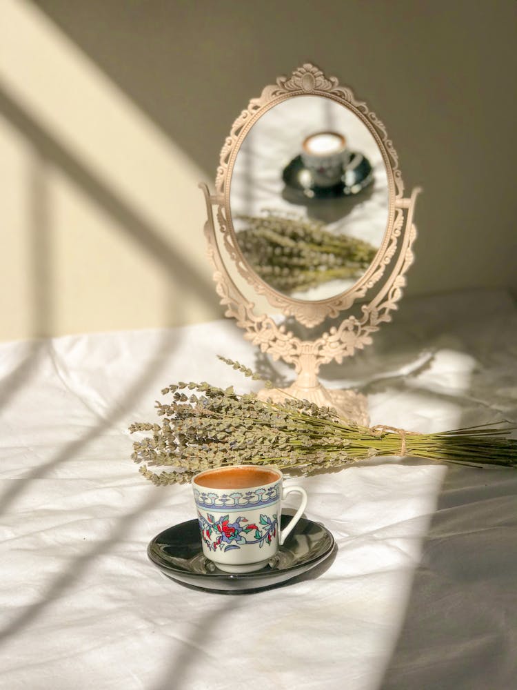 Cup Of Coffee Reflecting In Vintage Table Mirror 