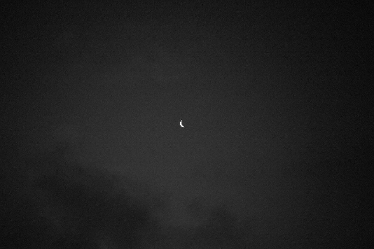 a serene crescent moon set against a dark night sky