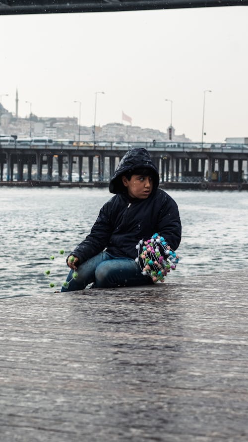 Boy Sitting at the River