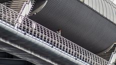 Woman in Black Shirt and Black Pants Walking on Stairs