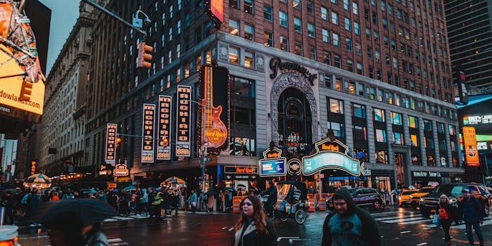 Bustling night scene at Times Square, New York City, featuring iconic buildings and lights.