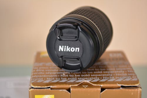 Black Nikon Lens over a Box