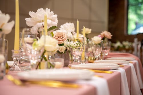 Flowers and Candles on Top of a Table