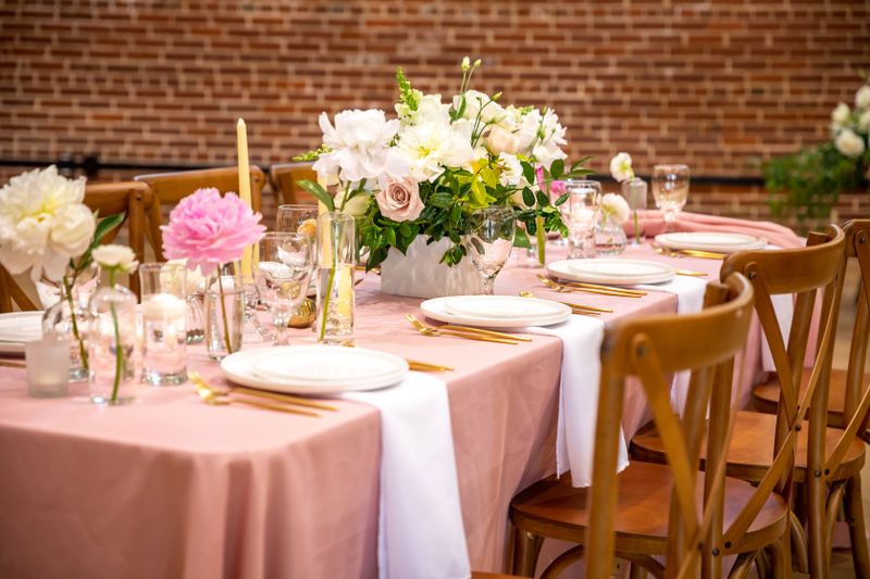 Florist arranging a romantic wedding centerpiece at a Charleston venue