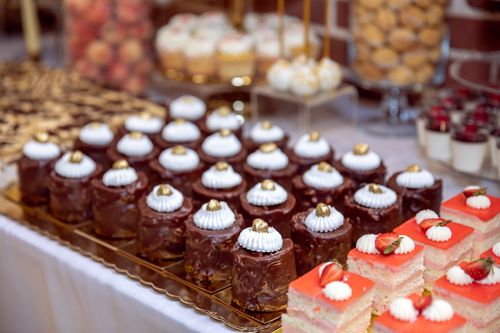 Free Close-up of assorted pastries and sweets artfully arranged on a dessert table. Stock Photo