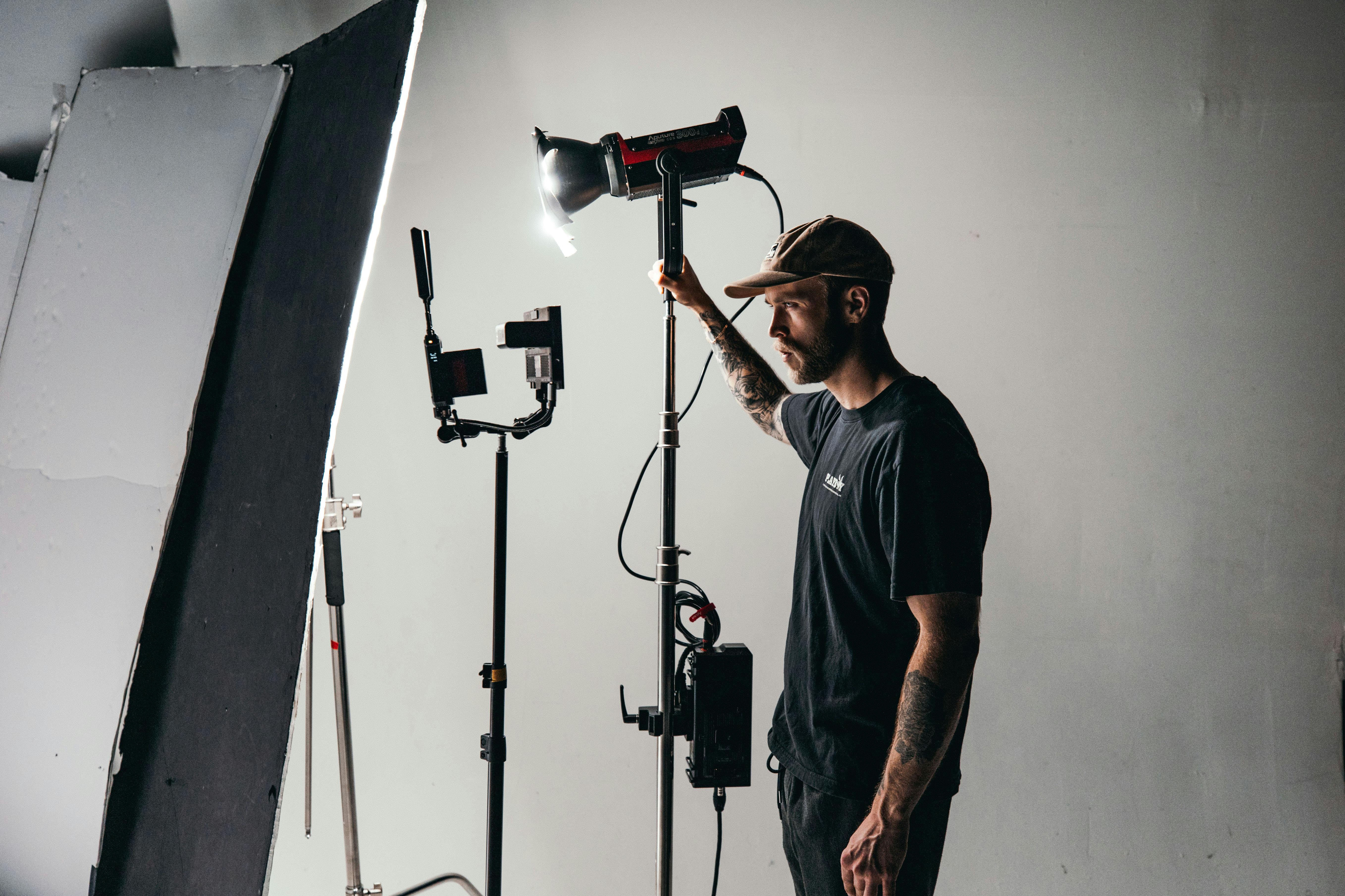 man in black crew neck t shirt standing near black microphone