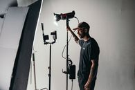 Man in Black Crew Neck T-shirt Standing Near Black Microphone