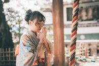 Woman in Green and Pink Floral Robe Covering Her Face With Her Hands