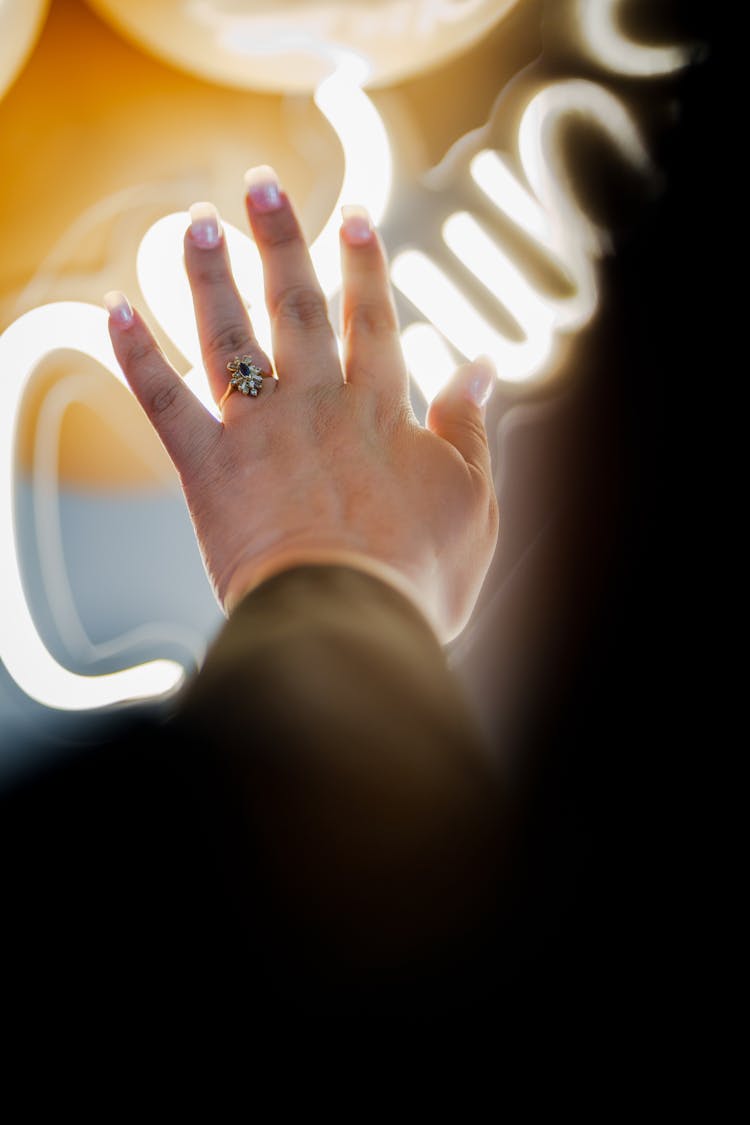 Woman Hand Touching Neon Light