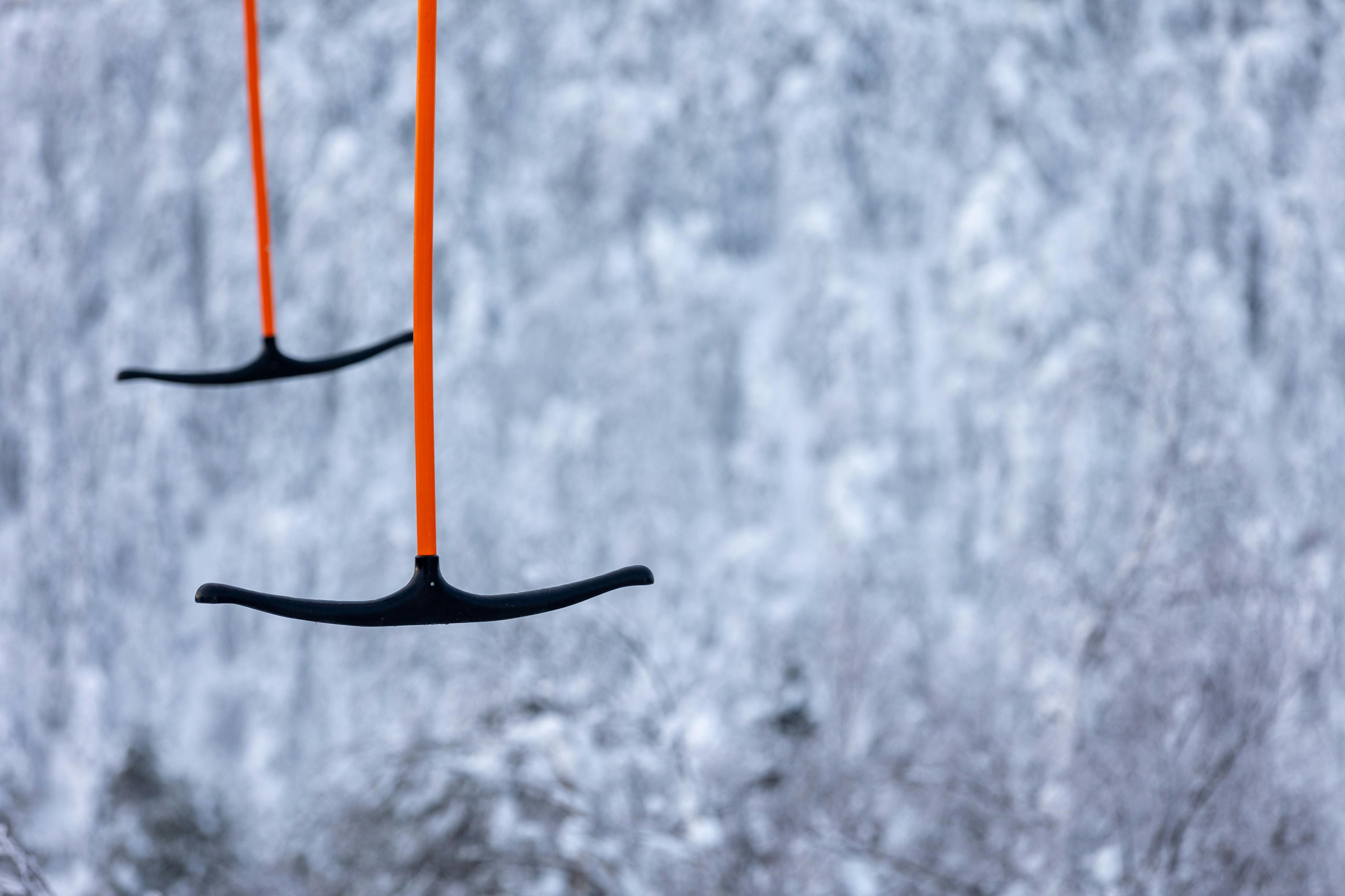 Prescription Goggle Inserts - Focused view of a T-bar ski lift against a snowy backdrop in Vuokatti, Finland.