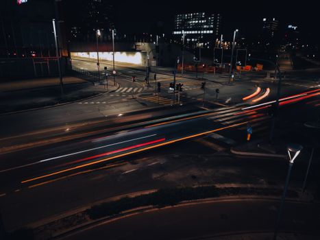Blurred light streaks of traffic in Milan at night, showcasing urban motion and transportation.