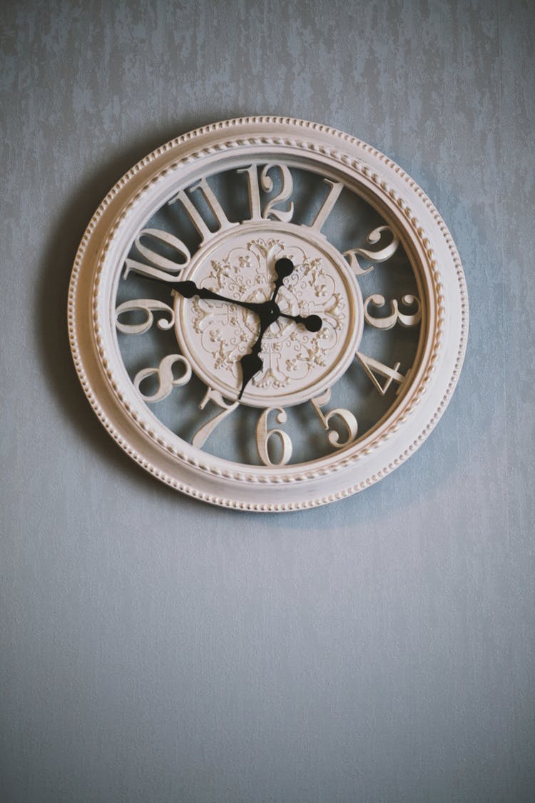 Round White Analog Clock Showing Time